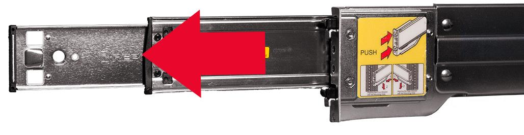 A metal server rail extended from its outer rail with a large red arrow overlaid pointing to the left, indicating the inner rail being pulled out.