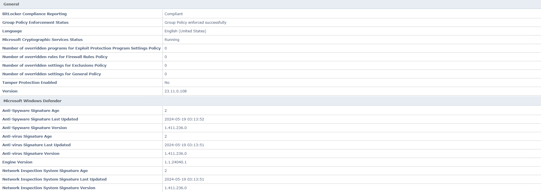 Screenshot of the Microsoft Windows Defender status table showing multiple rows and columns — sections titled General and Microsoft Windows Defender with fields such as BitLocker Compliance Reporting, Group Policy Enforcement Status, Language, Microsoft Cryptographic Services Status, Version, Anti-Spyware Signature Age, Anti-Spyware Signature Last Updated, Anti-virus Signature Age, Anti-virus Signature Last Updated, Engine Version, Network Inspection System Signature Age, and corresponding values.