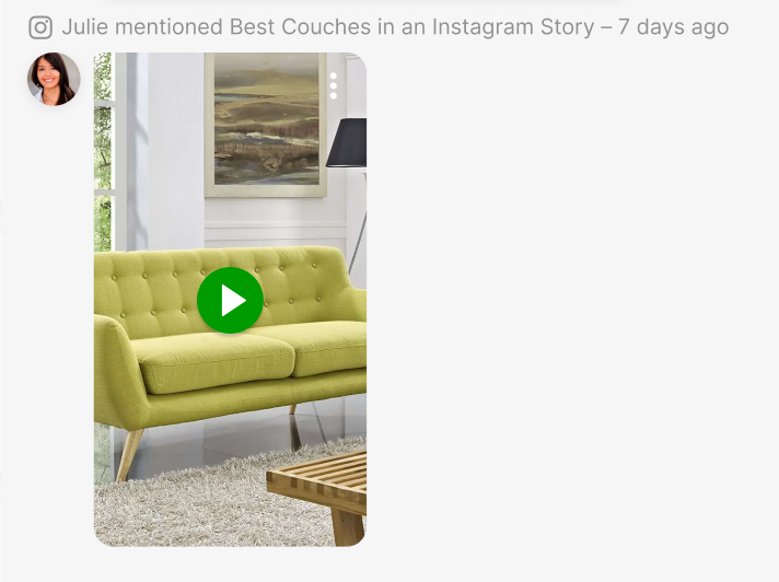 A stylish green couch in a bright living room with a coffee table and lamp.